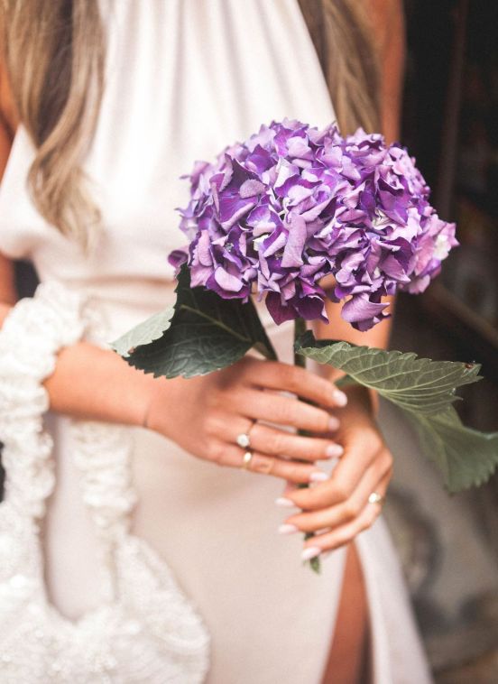 Bride holding a purple hydrangea bouquet