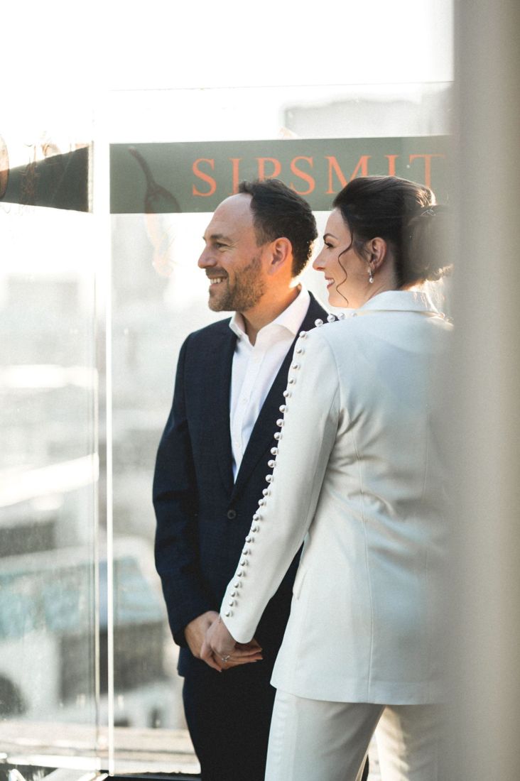 Couple holding hands at a city ceremony